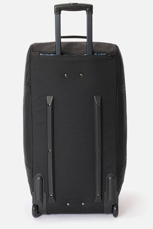 The Rip Curl Jupiter 80L travel bag in black stands upright on two inline skate wheels with an extended telescopic handle and reinforced corners, set against a plain white background.