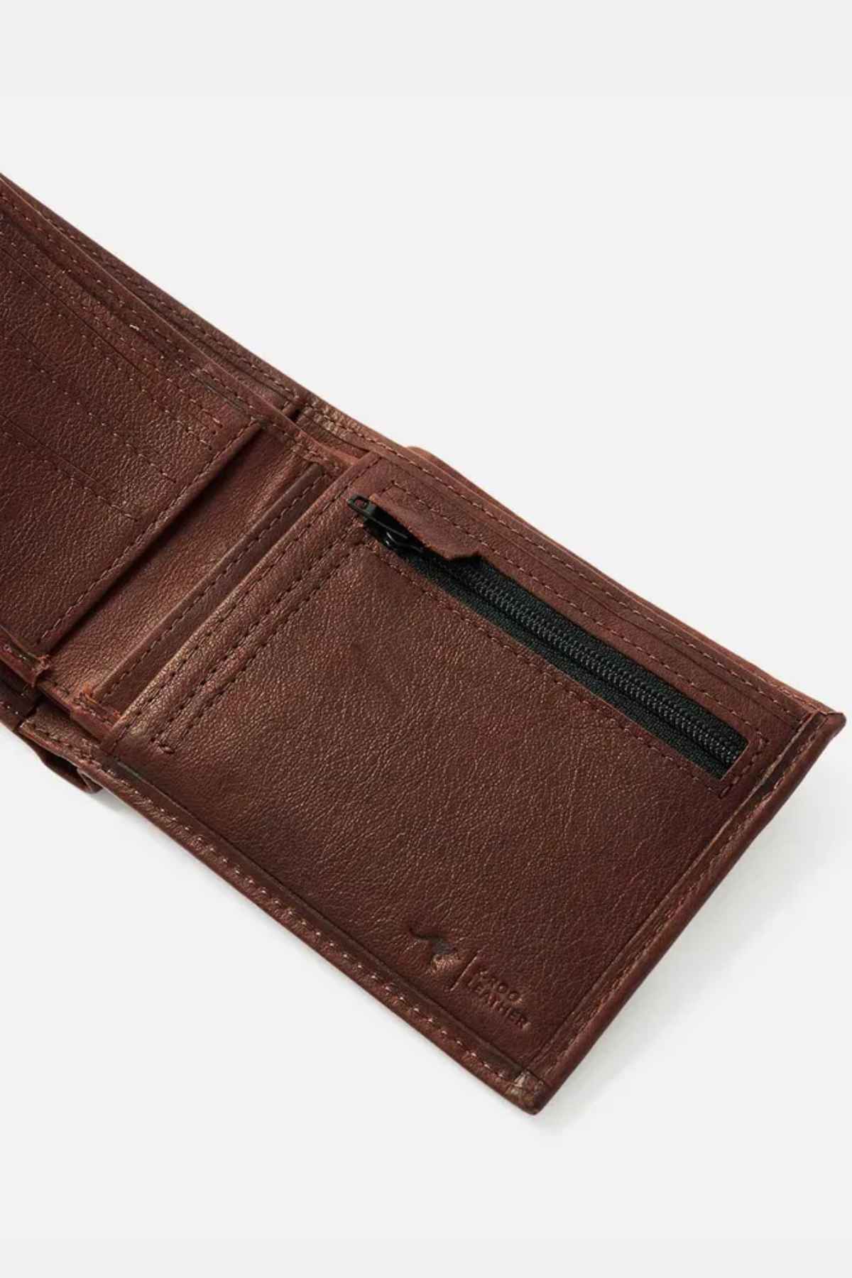 The Rip Curl K-Roo RFID 2 in 1 Wallet, made from brown kangaroo leather with a textured finish, opens to reveal several card slots and a zippered pocket. It offers durable construction and features built-in RFID protection.