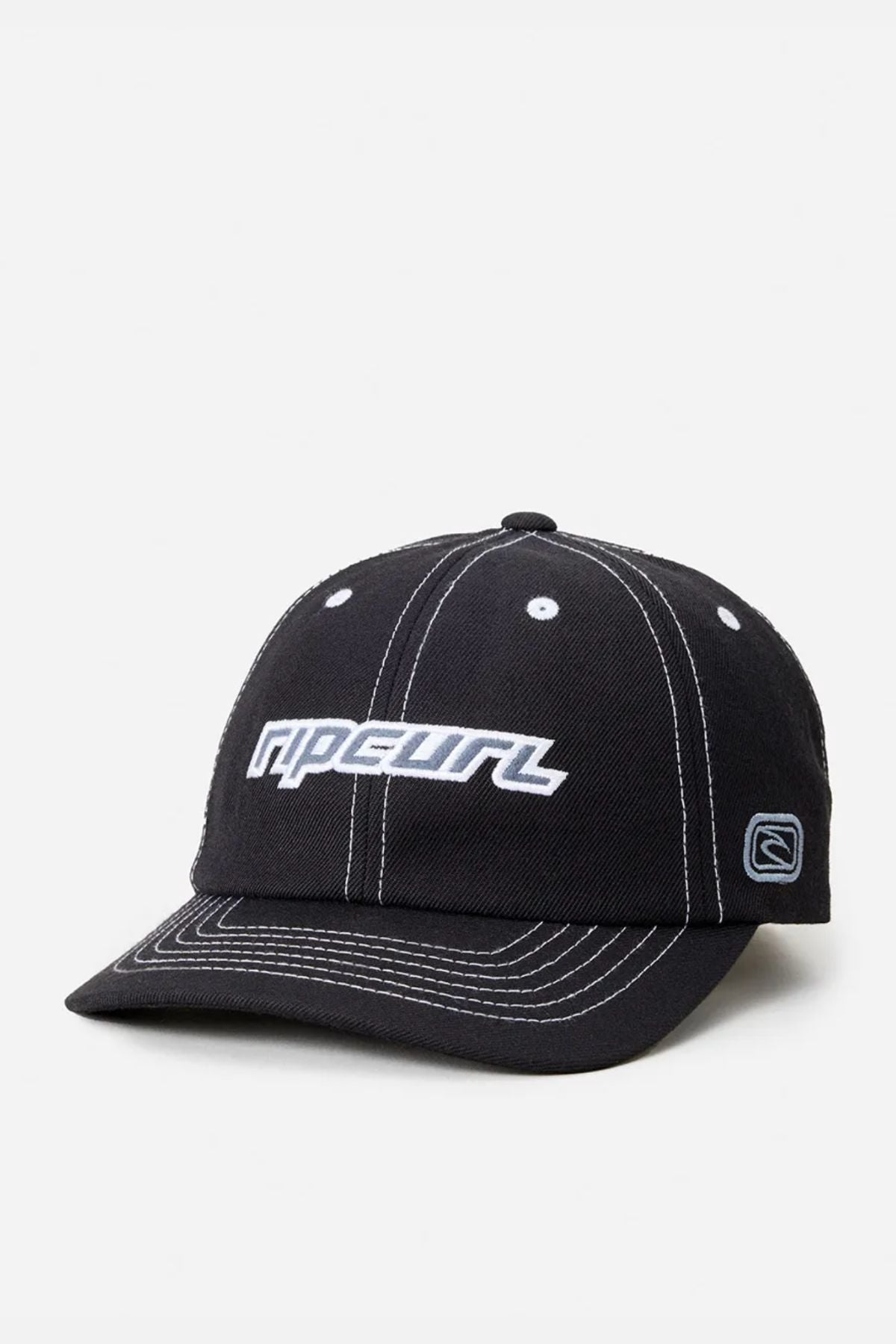 The Rip Curl Nu Dose Adj Cap is a black cotton twill cap with white stitching, featuring the Rip Curl logo embroidered in white and light blue on the front, a small side patch, and an adjustable strap for comfort.