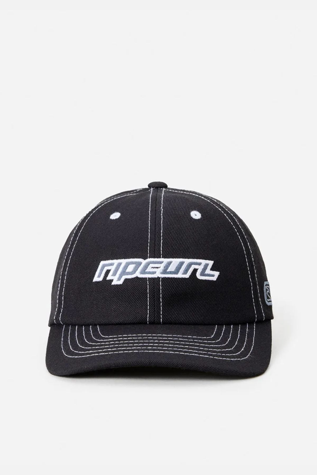 The Rip Curl Nu Dose Adj Cap is a black cotton twill cap with white stitching and "RIP CURL" embroidered in white on the front. This adjustable cap is shown on a plain light background.