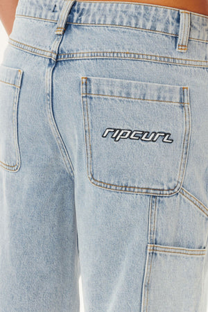 Close-up of the back of the Rip Curl Nu Dose Denim Walkshort in light blue, showing a carpenter pocket with the "ripcurl" logo embroidered in white and black thread.