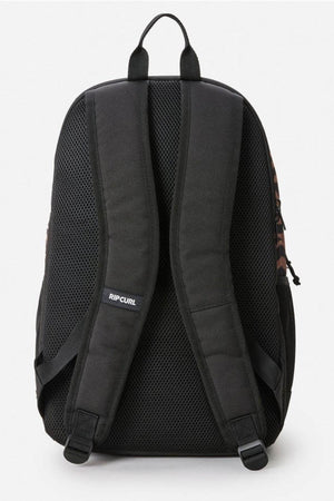 The Rip Curl Ozone 2.0 30L Backpack in black is shown from the back, featuring padded adjustable shoulder straps, a mesh back panel, spacious organiser pockets, and a top carrying loop.