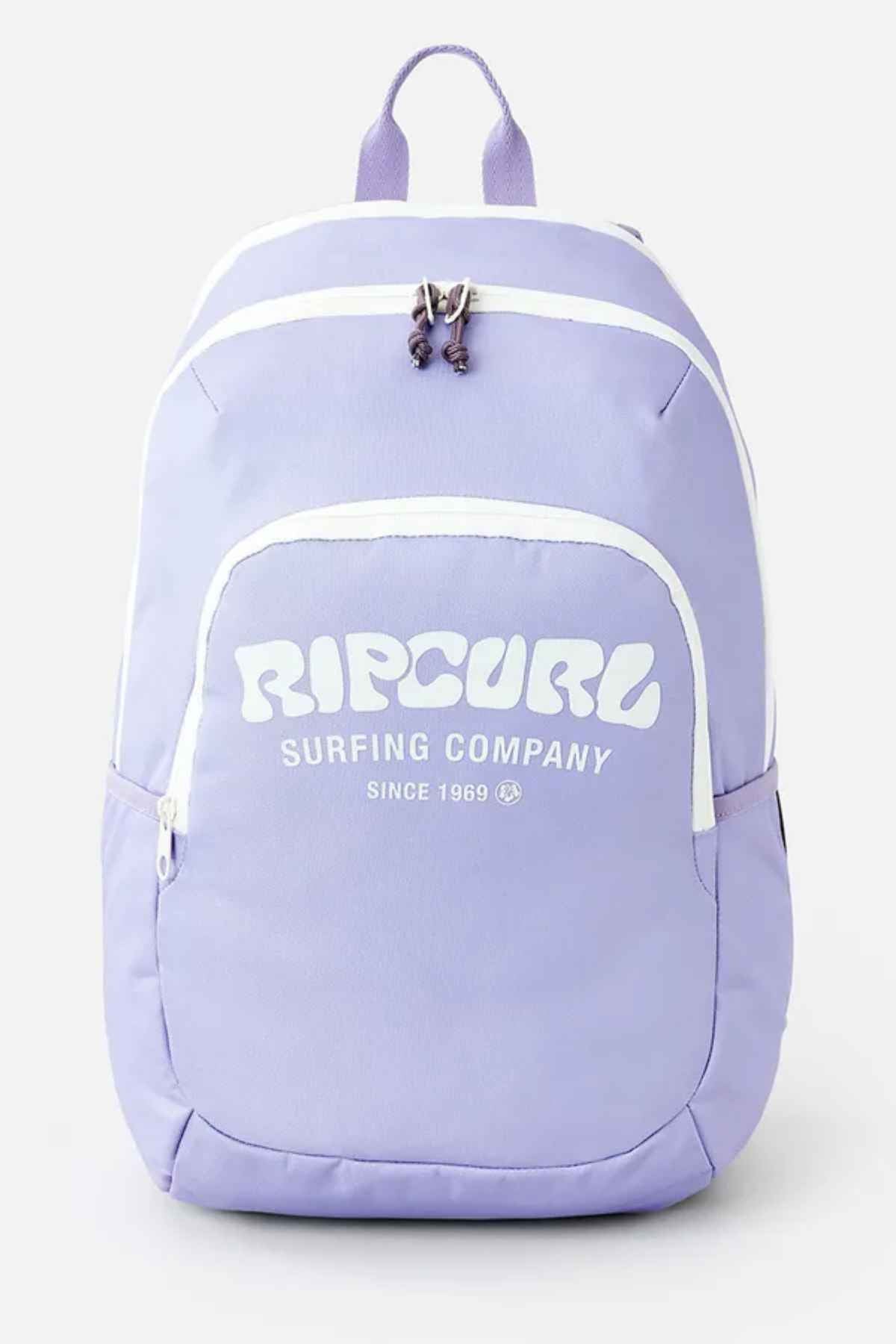 The Rip Curl Ozone 2.0 30L Backpack, in a light purple polyester design, showcases white accents along with the text "Rip Curl Surfing Company Since 1969" on the front. This versatile backpack features two main compartments with zipper closures and a top handle for convenient carrying.