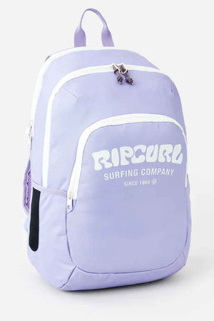 A light purple Rip Curl Ozone 2.0 30L Backpack with "SURFING COMPANY SINCE 1969" printed in white on the front. This durable polyester bag features multiple compartments, white zippers, a side pocket, and has a top handle along with visible shoulder straps.