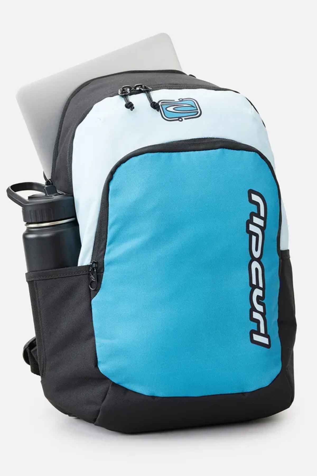 A Rip Curl Ozone 30L Back To School Backpack in blue and black showcases a partially visible laptop in the top compartment. This backpack includes a side pocket for a water bottle and displays a logo on the front, making it perfect as an ideal school backpack.
