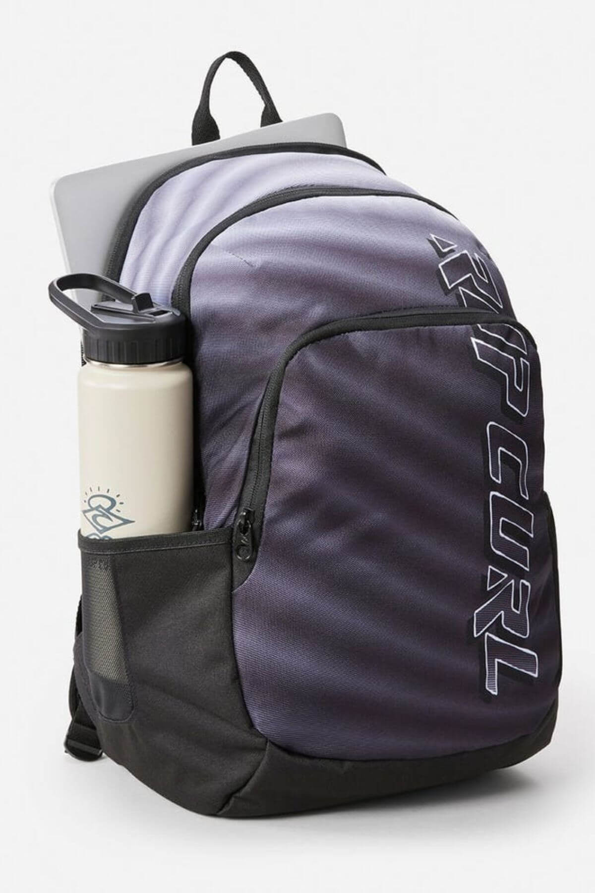 The Rip Curl Ozone 30L Faded Slant Backpack in gray and black features "Rip Curl" text, a large front pocket, breathable straps, a laptop peeking out of the top, and a logoed white water bottle in the side mesh pocket. Background is plain white.