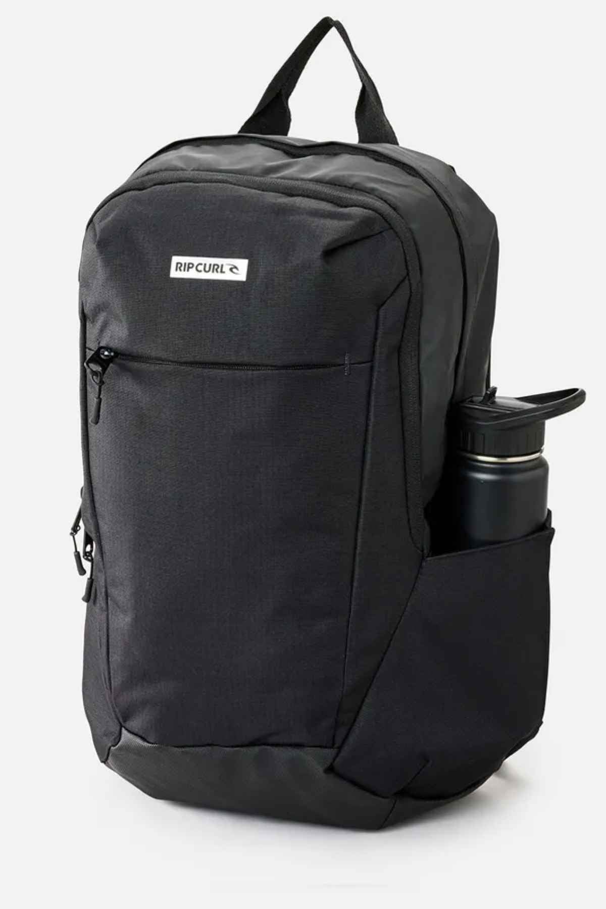 The Rip Curl Overtime 30L Icons Backpack is ideal for environmentally-friendly explorers. Featuring a sleek black design crafted from recycled polyester, it includes a front zipper pocket adorned with the "RIP CURL" logo, side compartments perfectly sized for a stainless steel water bottle, and a convenient loop handle at the top accessing its main zippered section.