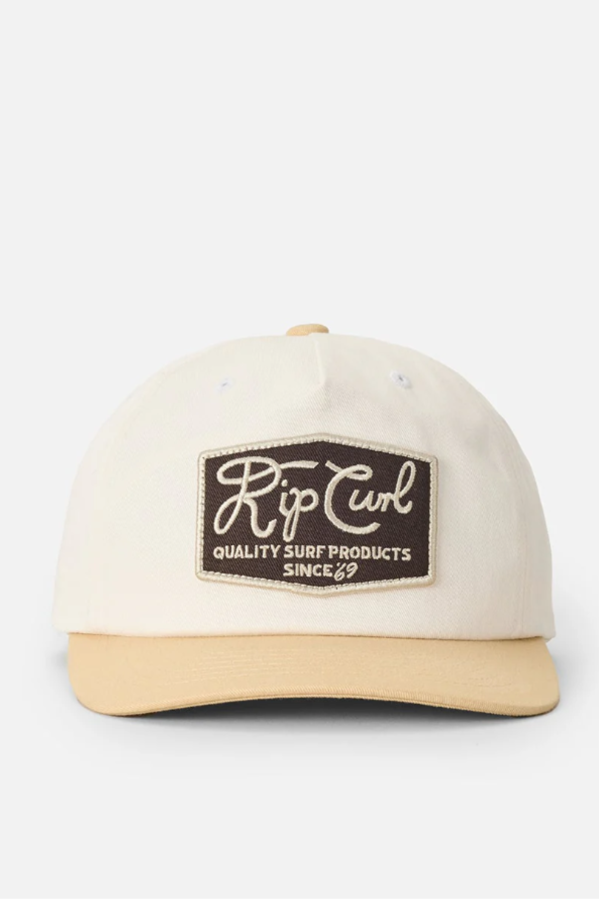 The Rip Curl Pacific Rinse SB Cap is a cream unstructured cap with a tan brim and a brown patch on the front reading "Rip Curl Quality Surf Products Since '69"—a stylish choice for your beachwear collection.