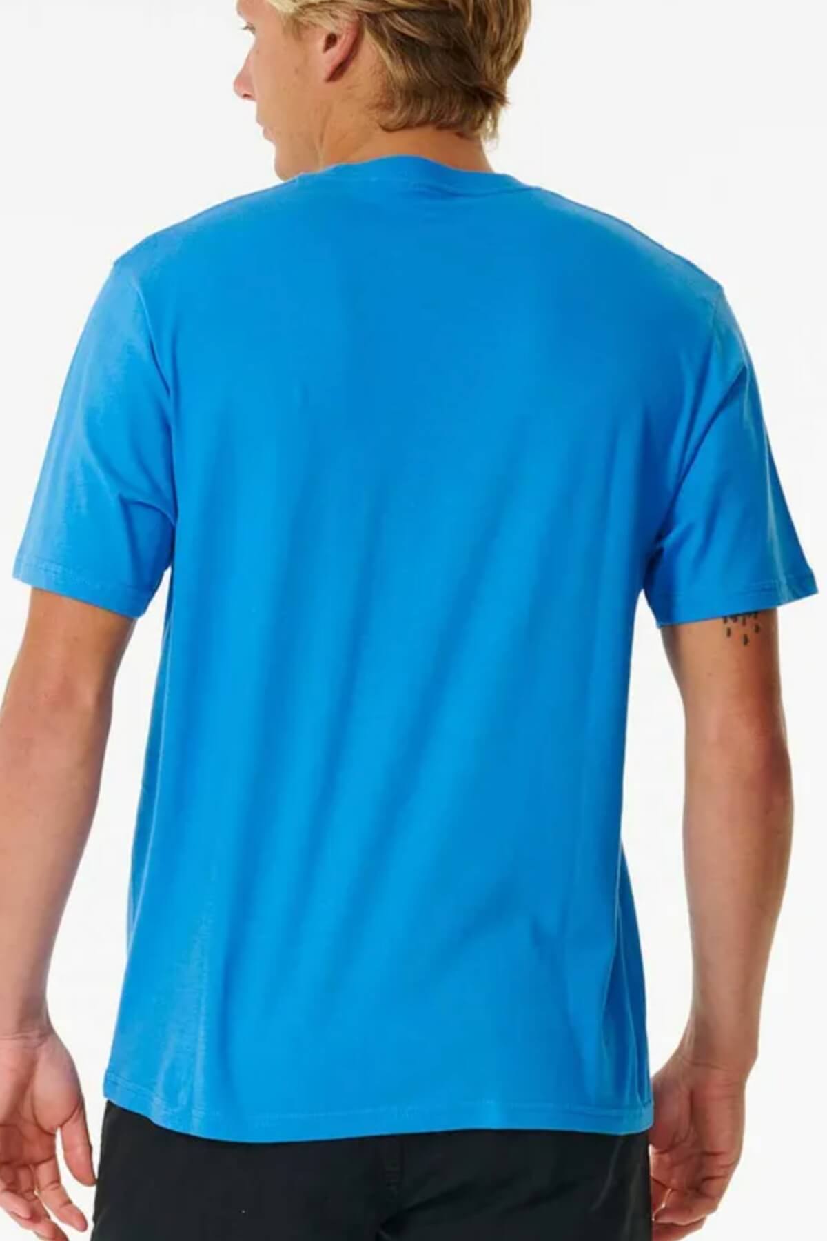 With light brown hair, they wear a bright blue short-sleeved Rip Curl Pill Icon Tee made of soft cotton. They're turned away, showing a tattoo on their left forearm. The T-shirt has a relaxed fit against a plain white backdrop.