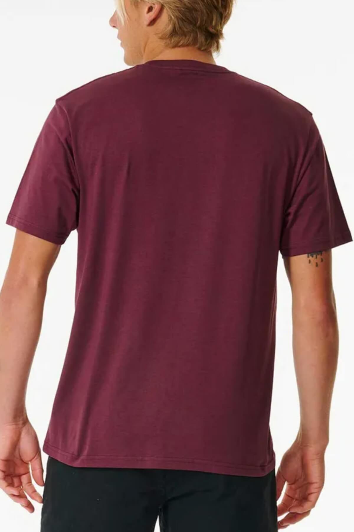 A blonde-haired person is seen from behind wearing the maroon Rip Curl Pill Icon Tee (100% cotton) with black pants, standing against a plain white background.