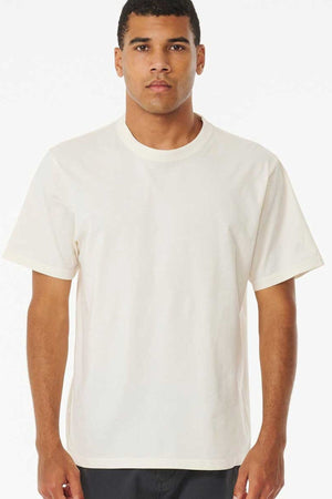 A person is facing forward, dressed in the Rip Curl Plain Wash Tee made from 100% cotton, ideal for any relaxed outing. The background is a plain white.