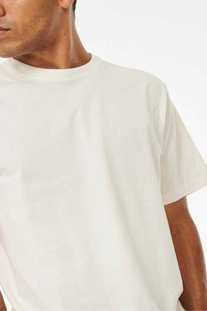 A person is partially visible, facing slightly to the left, and wearing a Rip Curl Plain Wash Tee made from 100% cotton. Ideal for casual occasions, the image highlights the upper section of the t-shirt against a simple backdrop.