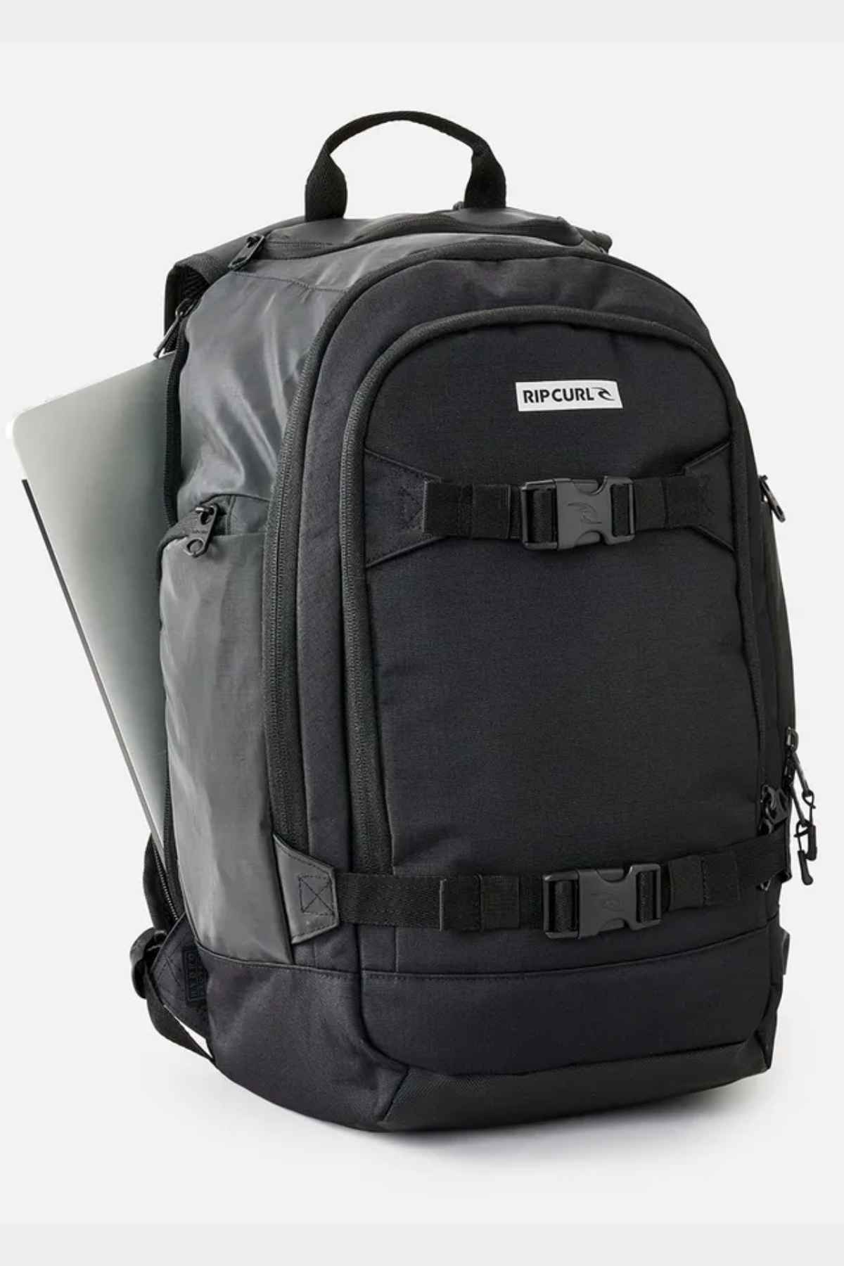 The Rip Curl Posse 33L Icons Backpack, made from recycled polyester, includes multiple compartments and adjustable straps. A laptop fits perfectly in the side pocket's dedicated section. Its sleek design makes it perfect for travel or daily use.