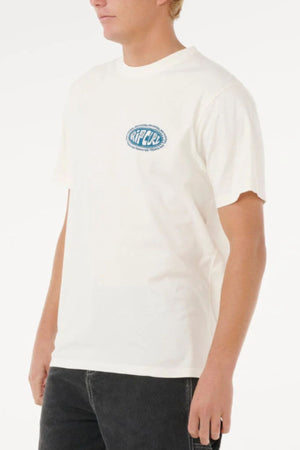 Wearing a plain white Rip Curl Raw Energy De Oval Tee with a small blue logo on the chest, paired with black jeans and standing against a white background.