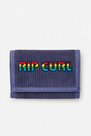 The Rip Curl Revival Cord Surf Wallet is a blue corduroy wallet with bold "RIP CURL" embroidery on the front and a secure Velcro closure for your essentials.