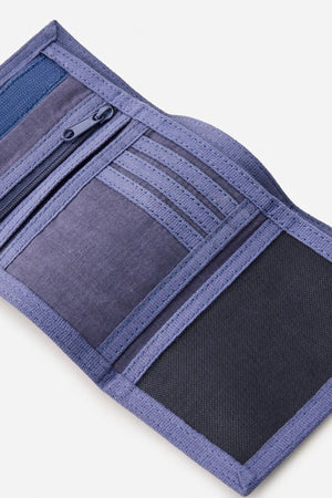 A Rip Curl Revival Cord Surf Wallet in purple lies open on a white background, revealing multiple card slots, a zippered pocket, and a mesh compartment.