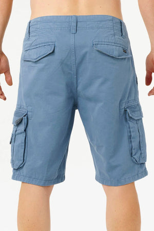 A person is shown from the back wearing Rip Curl Classic Surf Trail Cargo Shorts in light blue with multiple pockets, standing against a plain white background.