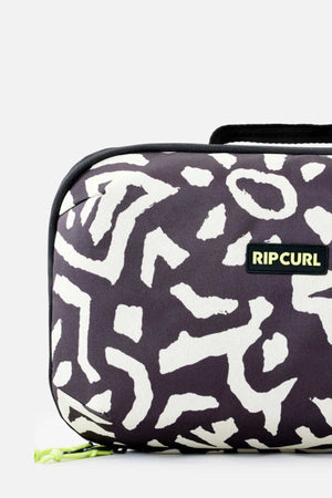 A detailed image showcases the Rip Curl Ultimate Beauty Case, adorned with a black and white abstract pattern. This travel toiletry bag features a nylon zipper, accented by a neon yellow zipper pull. The Rip Curl logo is prominently displayed on a black tag, making it an ideal travel companion for your beauty essentials.