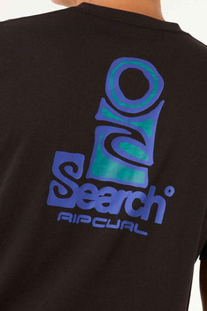 A person wearing the Rip Curl Vaporcool Search Stack Tee, which showcases a striking black T-shirt with a large, stylized blue logo displaying "Search" and "Ripcurl" in bold, modern fonts on the back. This shirt incorporates Vaporcool technology to provide moisture-wicking comfort while emphasizing design elements around the shoulder and neck area.