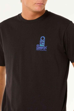 A person wearing the Rip Curl Vaporcool Search Stack Tee, a black t-shirt with a blue logo on the front, designed with Vaporcool technology for effective moisture-wicking and odor control. The image is cropped at the neck and shoulders.