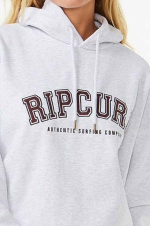 Someone dons a light gray Rip Curl Varsity Hoodie with "RIP CURL" and "Authentic Surfing Company" boldly printed on the front. This heritage fit hoodie, made from comfy Cotton Poly Fleece, includes a handy neck drawstring.