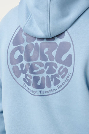 A close-up of the Rip Curl Wetsuit Icon Hood in light blue highlights the bold, wavy “RIP CURL WETSUITS” round Wettie Logo on the back, with “Torquay, Trestles, Hossegor.” written below.