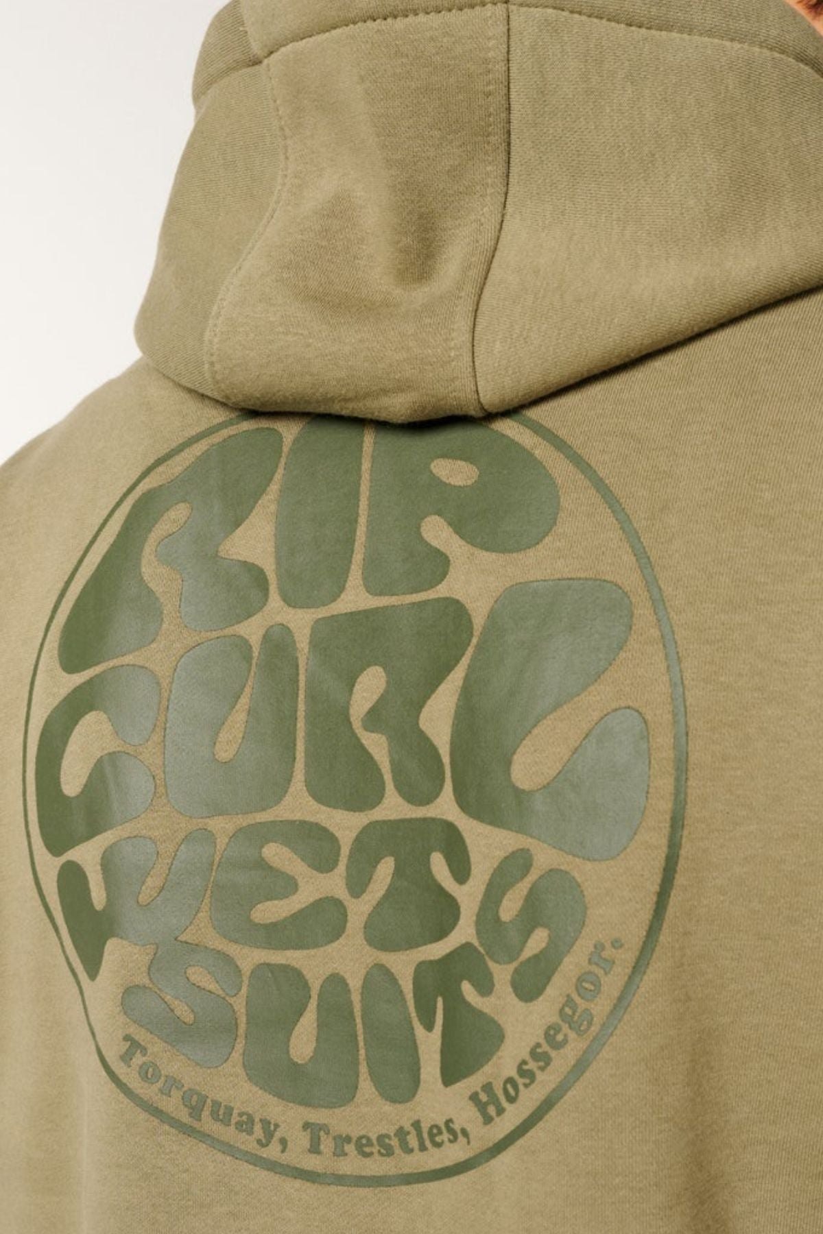 Close-up of the back of an olive-green Rip Curl Wetsuit Icon Hood, made from soft organic cotton fleece, featuring a circular "RIP CURL WETSUIT" logo with “Torquay, Trestles, Hossegor” beneath.