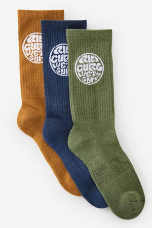 The Rip Curl Wetty Crew Sock 3 Pack includes mustard brown, navy blue, and olive green socks, each featuring a white circular Rip Curl logo near the top and providing excellent arch support for all-day comfort.