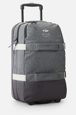 Introducing the Rip Curl F-Light Global 100L Classic Surf Travel Bag, a gray rolling suitcase crafted for surf travel enthusiasts. It features a sturdy telescopic handle and recycled polyester material, complemented by black and white accents. Complete with two front zippered compartments, compression straps, and small wheels for effortless mobility, it’s ideal for your next adventure.