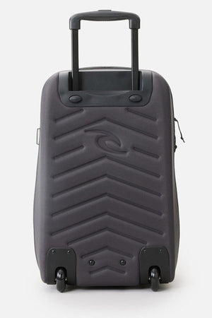 The Rip Curl F-Light Global 100L Classic Surf Travel Bag is a grey hard-shell suitcase made from recycled polyester. It features a retractable black handle, two wheels, and is adorned with a zigzag pattern and logo. Ideal for surf travel, it includes compression straps to keep your belongings secure.