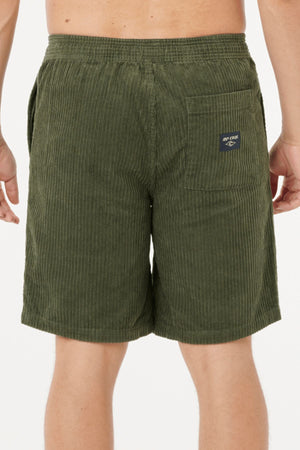 A person wearing olive green Rip Curl Classic Surf Cord Volley shorts, viewed from the back. The shorts feature a visible back pocket with a small navy patch. The background is plain white.