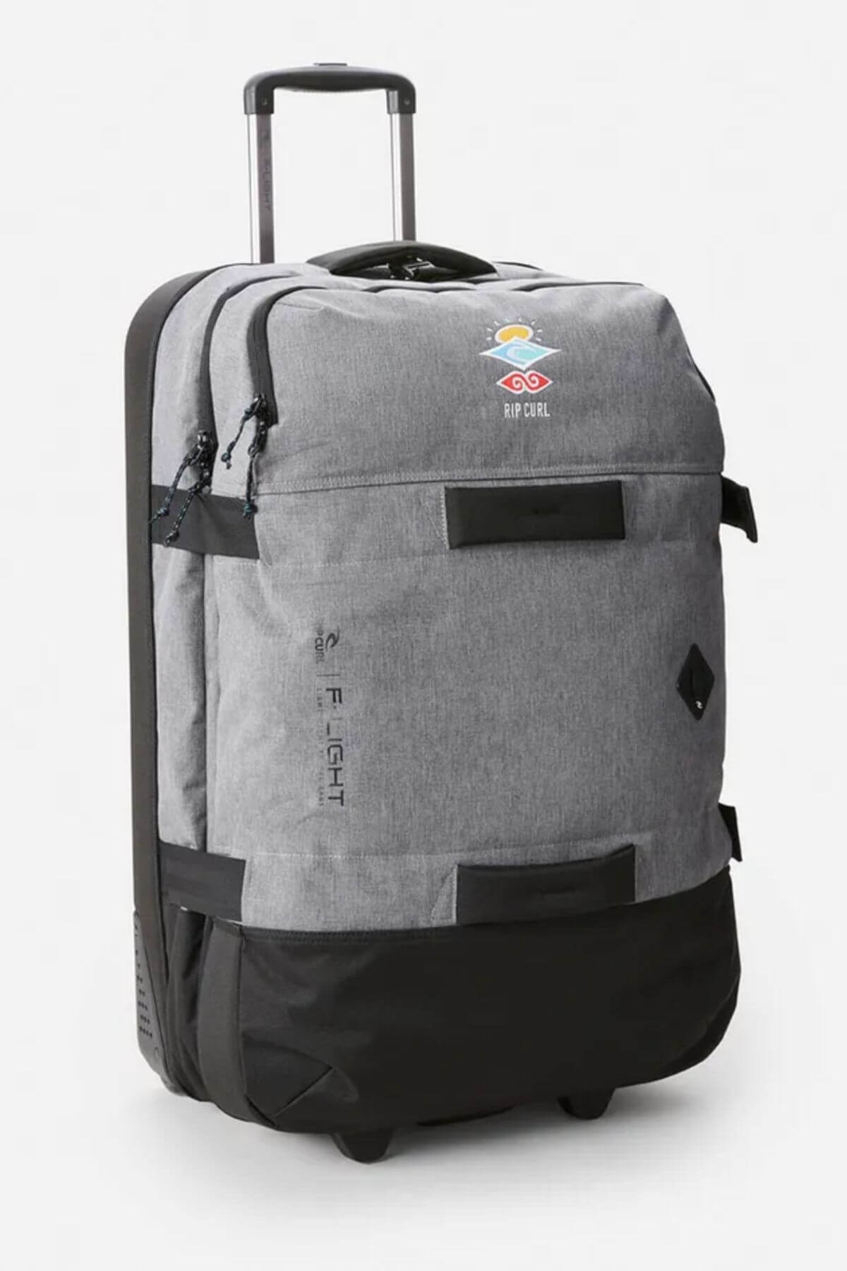 The Rip Curl F-Light Global 110L Icons Travel Bag is grey and black, featuring a telescopic handle, multiple zippered compartments, compression straps for secure packing, and a small front Rip Curl logo.