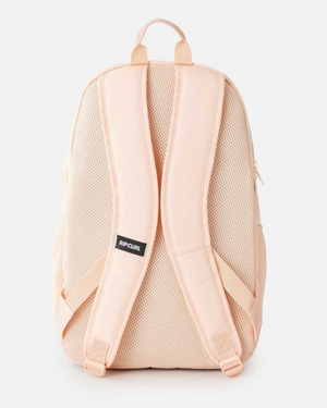 Back view of the Rip Curl Ozone 2.0 30L backpack in pastel pink, featuring adjustable padded straps, a breathable mesh back panel, and a small black logo tag. Made from 100% recycled polyester, it includes a top handle and an interior laptop section for convenience.