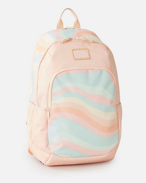 The Rip Curl Ozone 2.0 30L Backpack in pastel pink features a front pocket with wavy stripes in light blue, peach, and cream. It's made from 100% recycled polyester and includes a laptop section, top handle, and adjustable shoulder straps on a crisp white background.