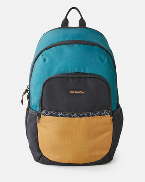 The Rip Curl Ozone 30L Journeys Backpack features a teal top, black middle, and mustard yellow front pocket made from recycled polyester. It includes a black and white patterned strip above the rectangular logo patch, with adjustable straps and a top handle, ideal for any adventure.