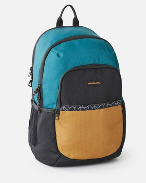 The Rip Curl Ozone 30L Journeys Backpack features teal, black, and tan sections with a stylish small black logo patch on the front pocket. Made from recycled polyester, it includes side mesh pockets and dark patterned trim. With a top handle and dual zippers, it's ideal for everyday use.