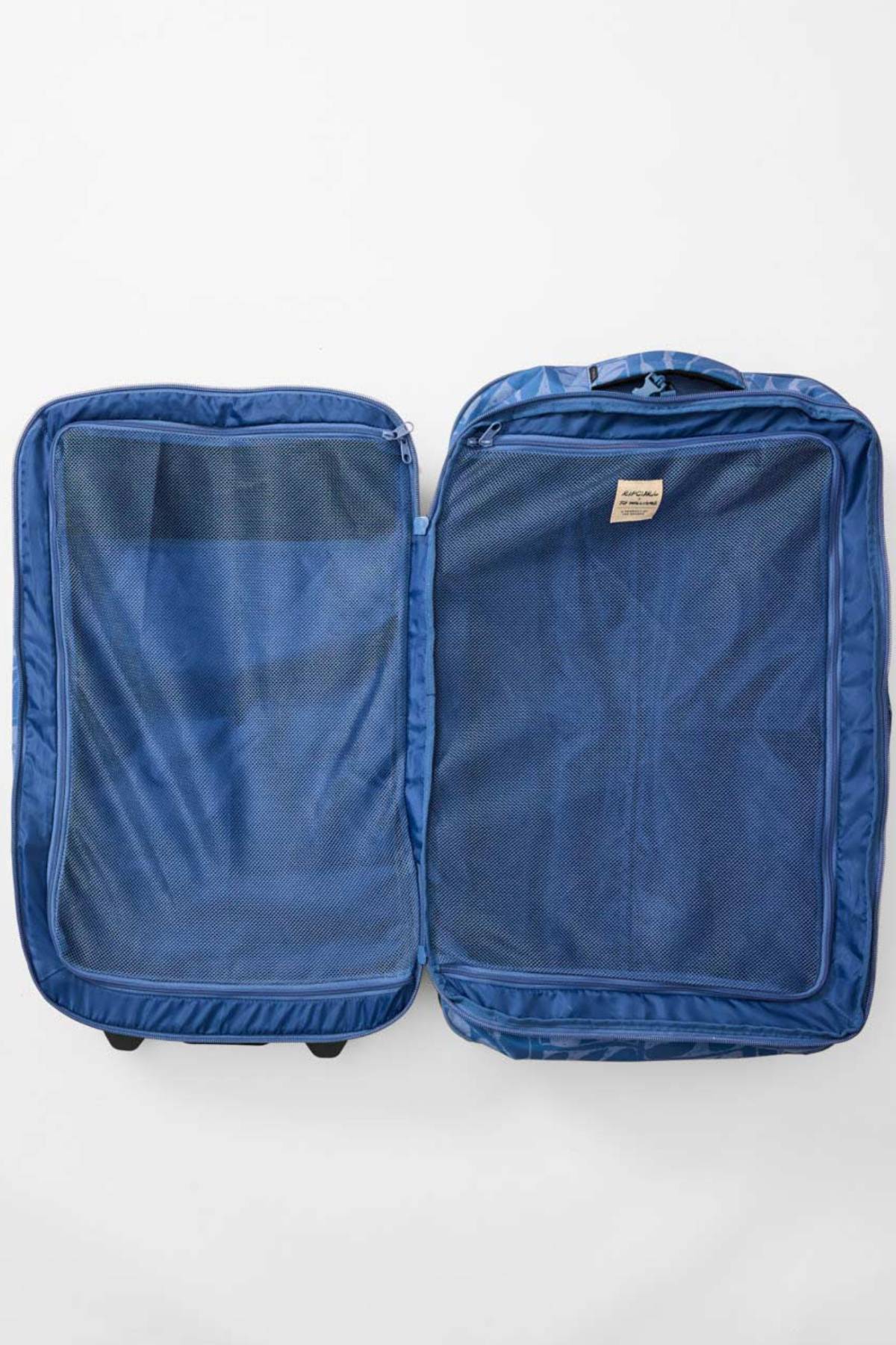 The Rip Curl F-Light Artist Of The Search Ty Williams 100L Global Travel Bag—an open, empty blue suitcase with mesh zip compartments on both sides—lies flat on a white surface, ready for your next adventure.