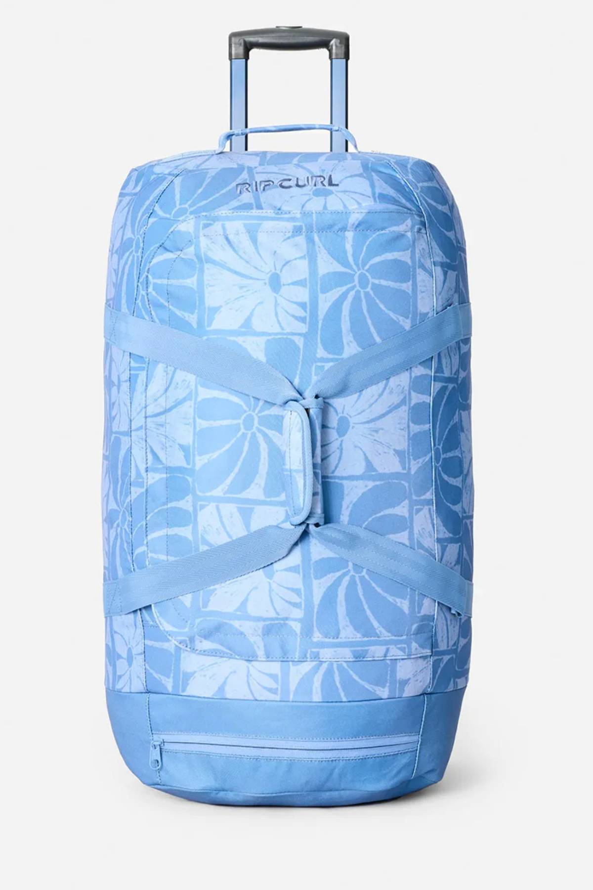 The Rip Curl Jupiter 80L Mixed Travel Bag is a spacious blue travel bag with a pull handle, floral geometric pattern, crossed front straps, and a bottom zipper pocket—perfect for stylish and organized adventures.