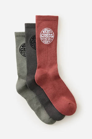 The Rip Curl Wetty Crew Sock 3 Pack includes green, dark gray, and red ribbed crew socks with "WEST SIDE" emblems near the top and built-in arch support for comfort.