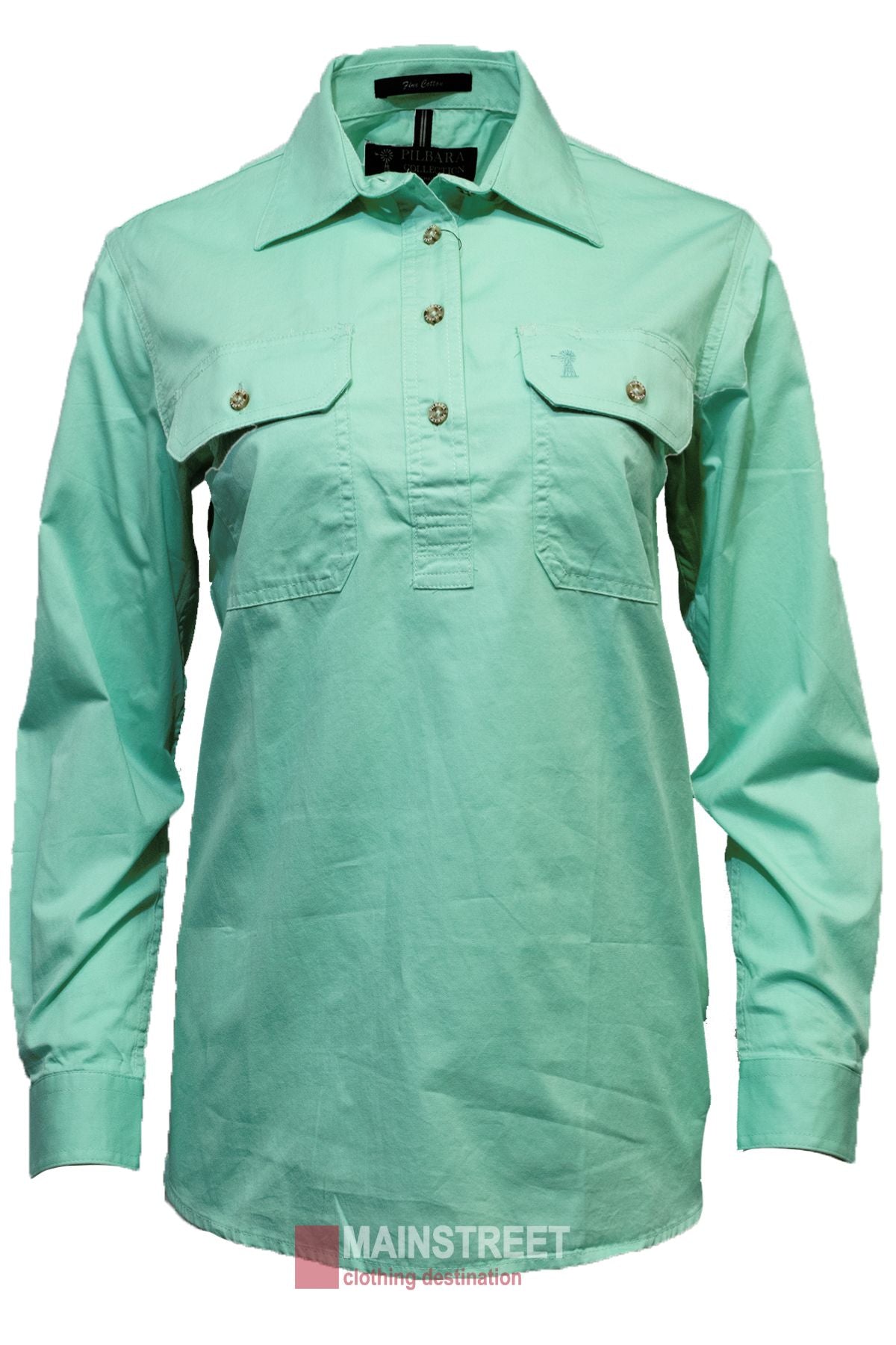 The Pilbara Ladies Long Sleeve Closed Front Shirt is mint green, 100% cotton, and boasts a UPF 50+. With two buttoned chest pockets and a collar, it is stylishly displayed on a mannequin against a plain white background.