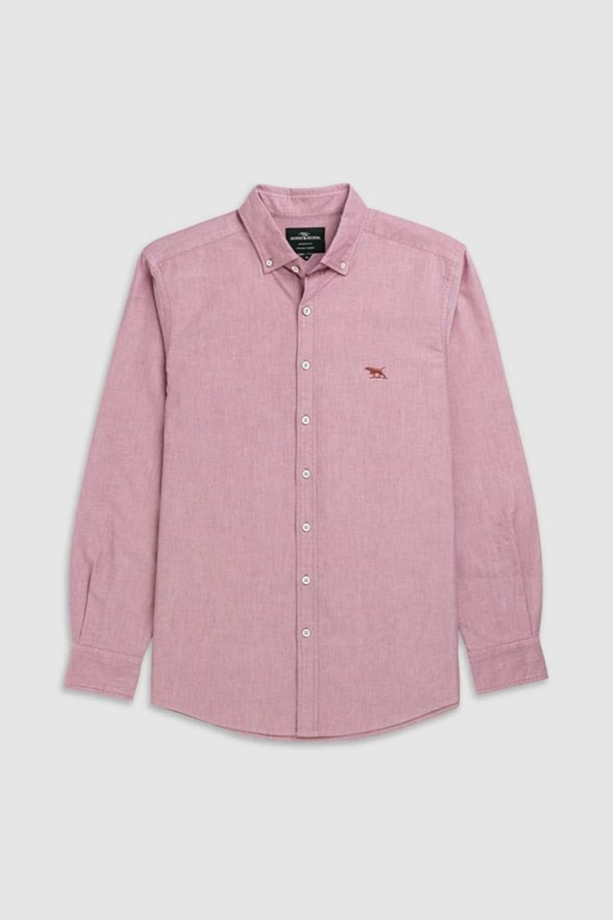 The Rodd & Gunn Gunn Oxford Sports Fit Shirt is a stylish, long-sleeved, light pink 100% cotton shirt with a collar, white buttons, and small embroidered logo on the left chest, displayed flat on a light gray background.
