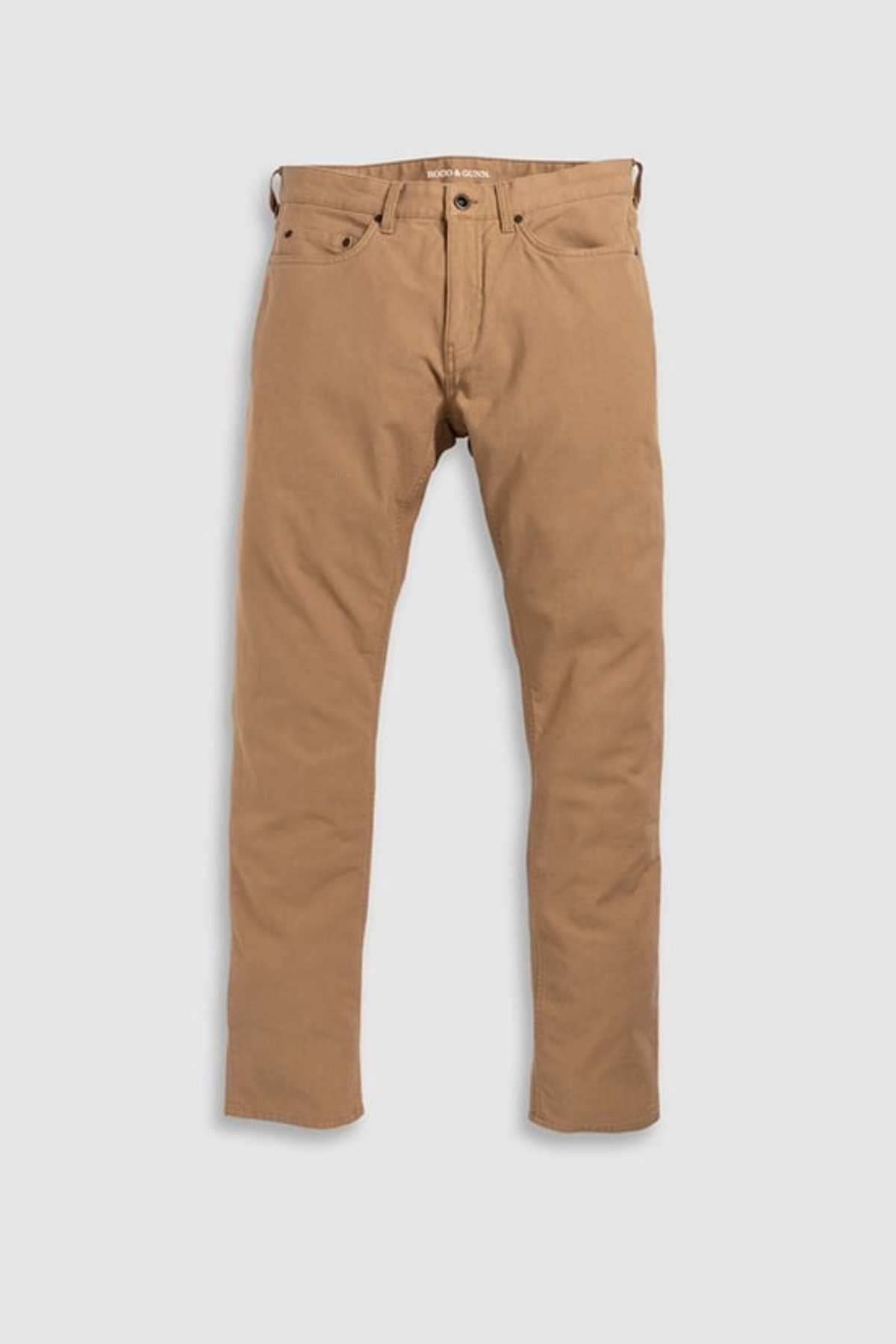 The Rodd & Gunn Motion 2 Straight Jean in brown is laid flat on a white surface. Made from comfort stretch motion fabric, these jeans allow for ease of movement and feature a classic five-pocket design with a YKK zip fly and button closure, offering both style and functionality.