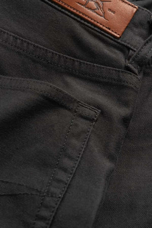 Close-up of Rodd & Gunn Motion 2 Straight Jean in black denim, showcasing comfort stretch fabric, a side pocket, a brown leather patch on the waistband, and a durable YKK zip fly.
