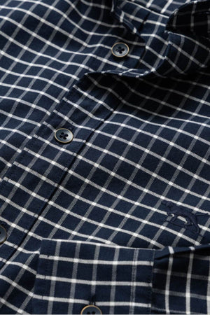 Close-up of the Rodd & Gunn Gunn Check Oxford 3 Sports Fit Shirt in navy blue and white, crafted from premium Australian cotton, featuring four buttons and a chest pocket with an embroidered logo.