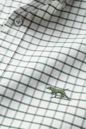 A close-up of the Rodd & Gunn Gunn Check Oxford 3 Sports Fit Shirt, made from Australian cotton with a green check pattern and a small green dog embroidery near the bottom center.
