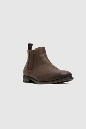 The Rodd & Gunn Ealing Chelsea Boot in brown oiled leather features a black pull tab, elastic side panels, low heel, and a flexible rubber outsole. Shown single on a plain light gray background.