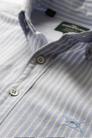 Close-up of the Rodd & Gunn Gunn Oxford Stripe 4 Of Shirt in light blue and white, made from pre-washed cotton, featuring white buttons and an embroidered horse logo on the chest.