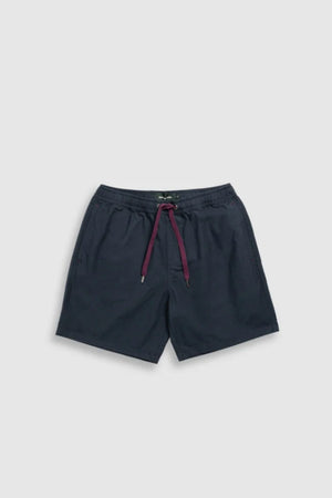 The Rodd & Gunn Resort Short is a navy blue cotton casual short featuring an elastic waistband, maroon drawstring, side pockets, and a relaxed fit for comfort. Shown flat on a light gray background.