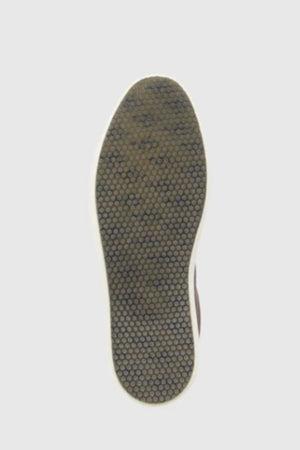 The image displays the sole of a Rodd & Gunn Transit Sneaker, showcasing a dark brown hexagonal tread pattern with a white border, set against a plain light gray background.