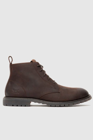 The Rodd & Gunn Clearview Chukka Boot in brown USA crazyhorse leather features a lace-up front, a back pull tab, and a rugged translucent rubber outsole, displayed on a plain light gray background.